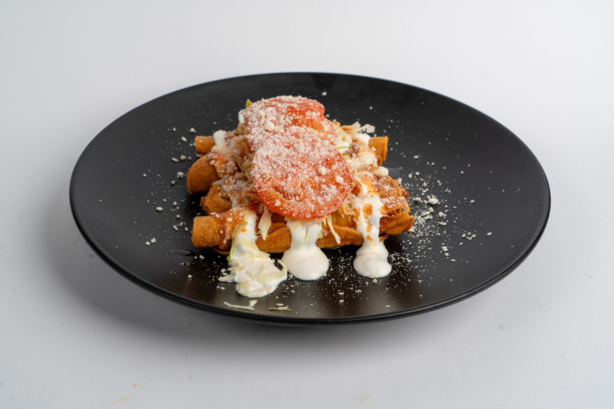 Crispy chicken flautas with sour cream and cotija cheese