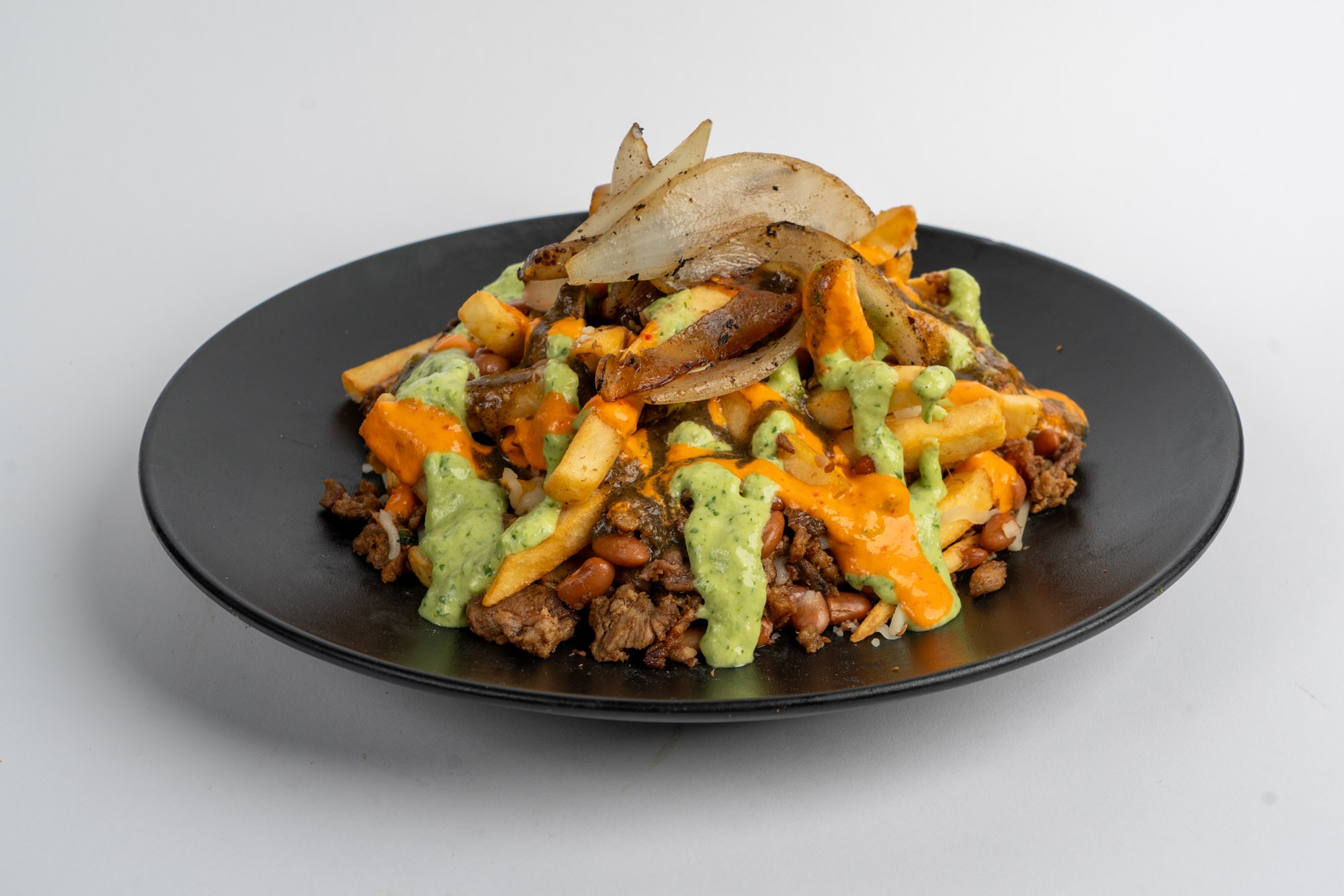 Loaded Mexican fries with cheese meat and three salsas